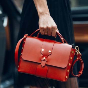 Model met close-up van rode handtas
