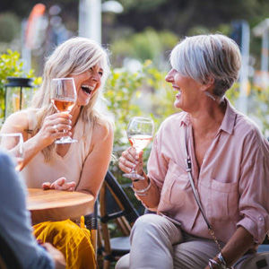 2 Vrolijke dames op terras met wijntje